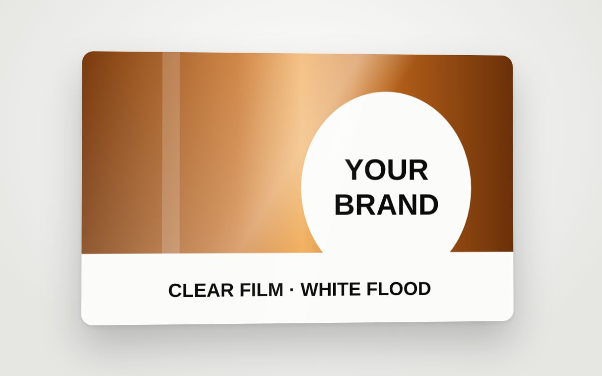 A clear-film product label with a white flood behind the brand area