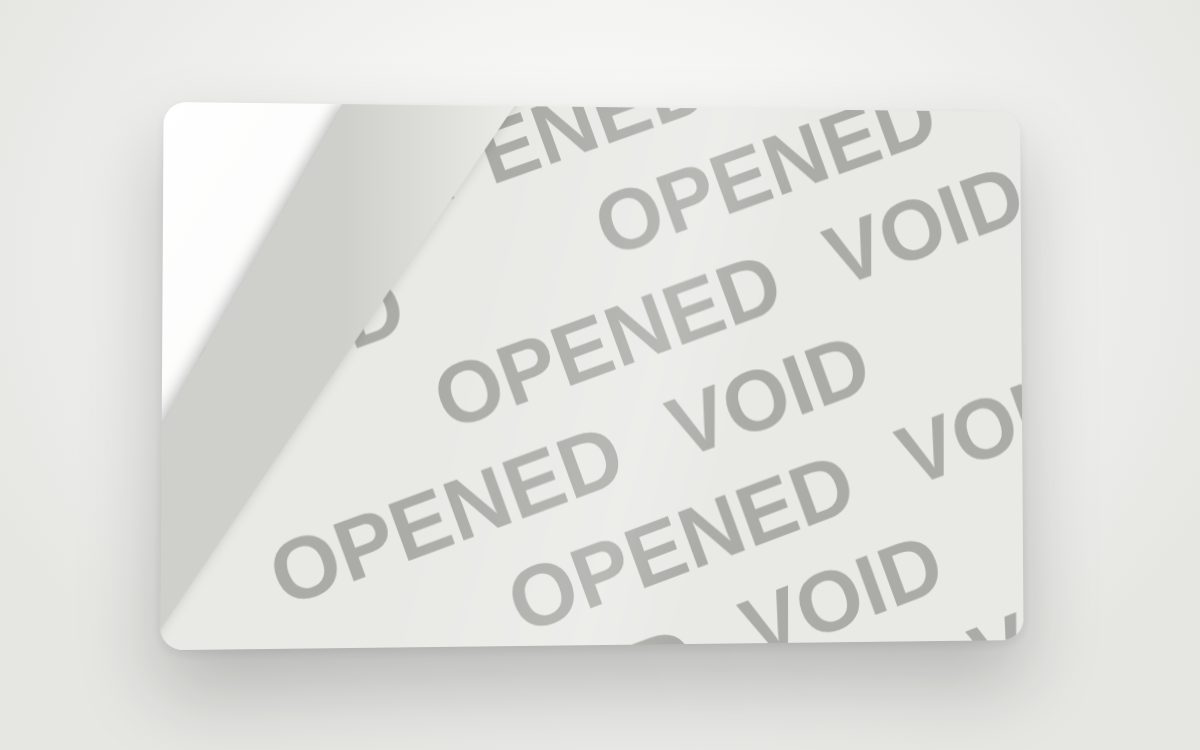 A tamper-evident label peeled back to reveal an OPENED VOID pattern underneath