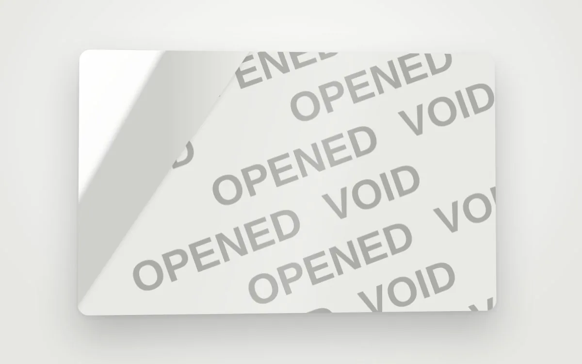 A tamper-evident label peeled back to reveal an OPENED VOID pattern underneath